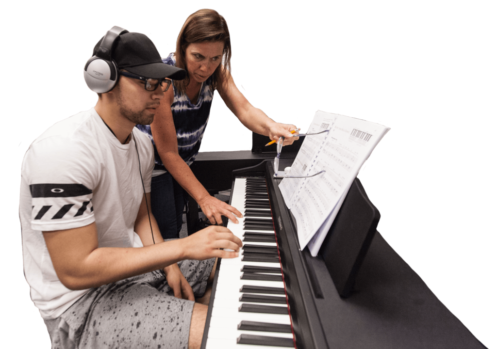 Music Faculty Member with student teaching the piano